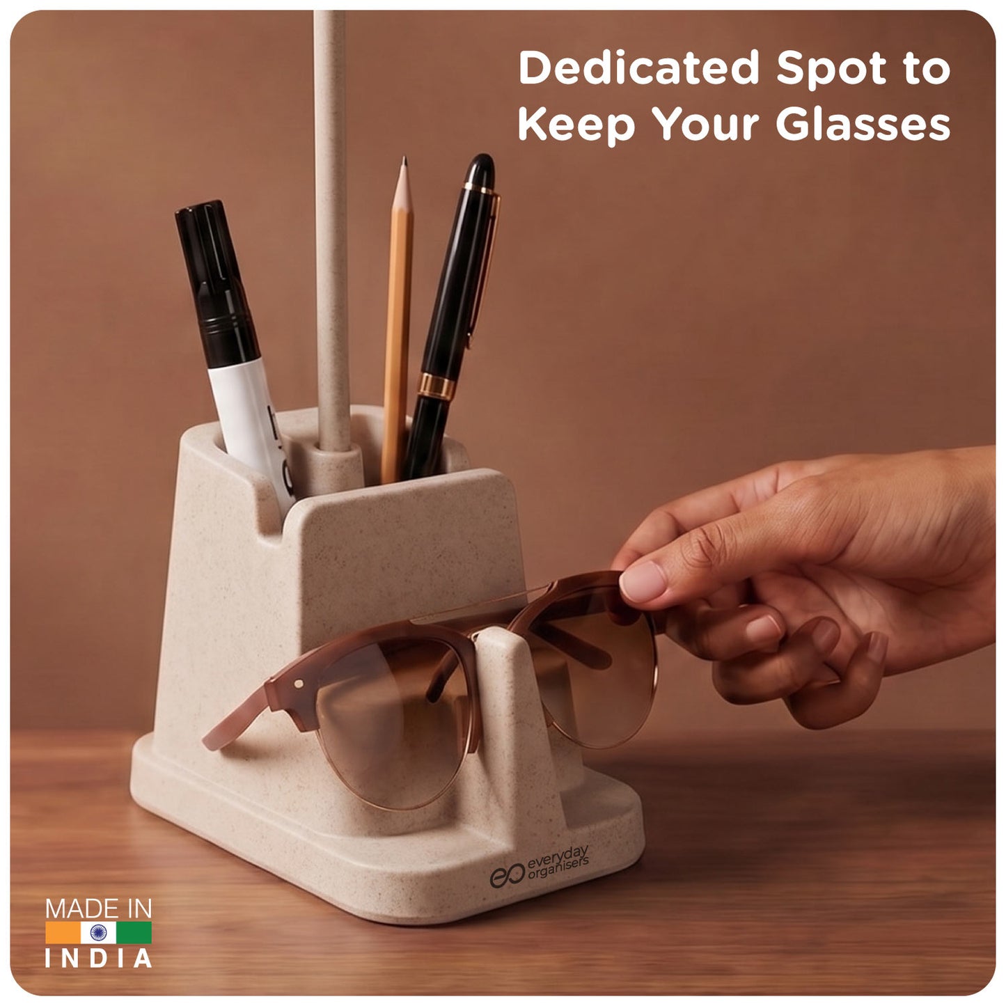 Hand placing sunglasses on the front glasses rest of eo Desk Station Lite